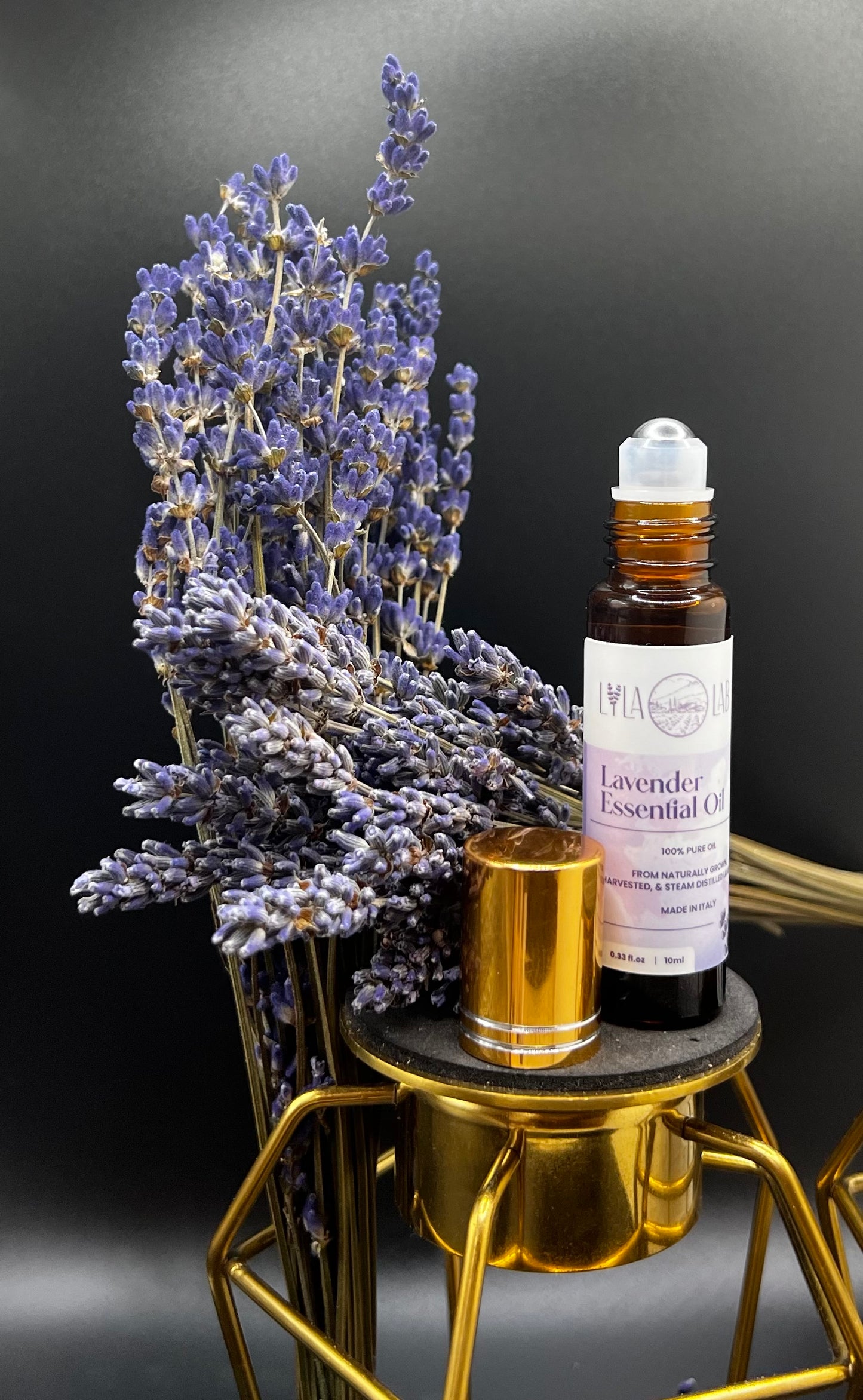 Two bottles of Lavender Essential Oil with droppers, one in a landscape setting with lavender fields and the other with a person lying down, presumably using the oil for aromatherapy.