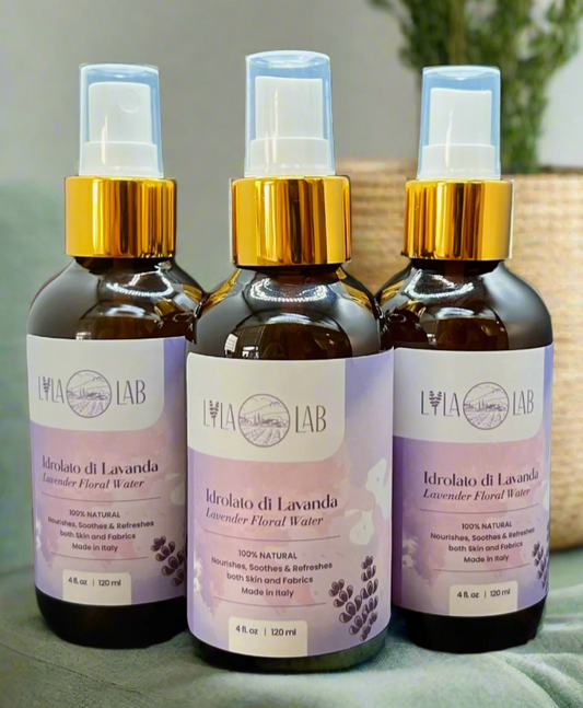 Three bottles of Lavender Hydrosol - Floral Water with spray tops, placed on a surface with a plant in the background.
