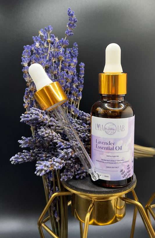 Two bottles of Lavender Essential Oil with droppers, one in a landscape setting with lavender fields and the other with a person lying down, presumably using the oil for aromatherapy.